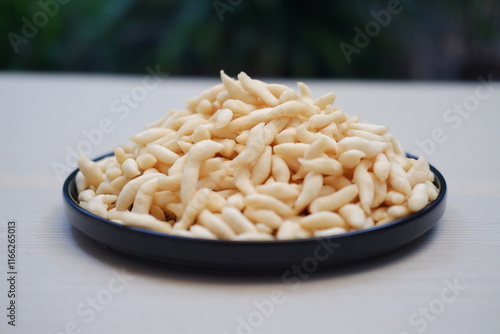 telur gabus sticks on black plate with wooden table