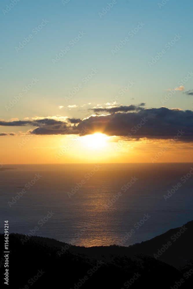 A stunning sunrise over the horizon in Japan, with sunlight reflecting off the ocean and creating a radiant path on the water. A stunning sunrise over the horizon in Japan, with sunlight reflecting off the ocean and creating a radiant path on the water.