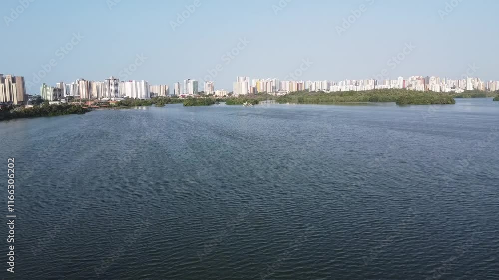 aerial image of a large lake with buildings in the background aerial image of a large lake with buildings in the background