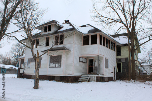 Abandoned and boarded American four square home in winter in Flint, Michigan photo