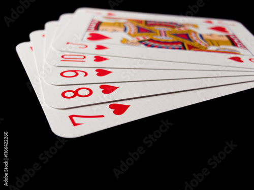 A deck of playing cards with the number 7 on the bottom photo