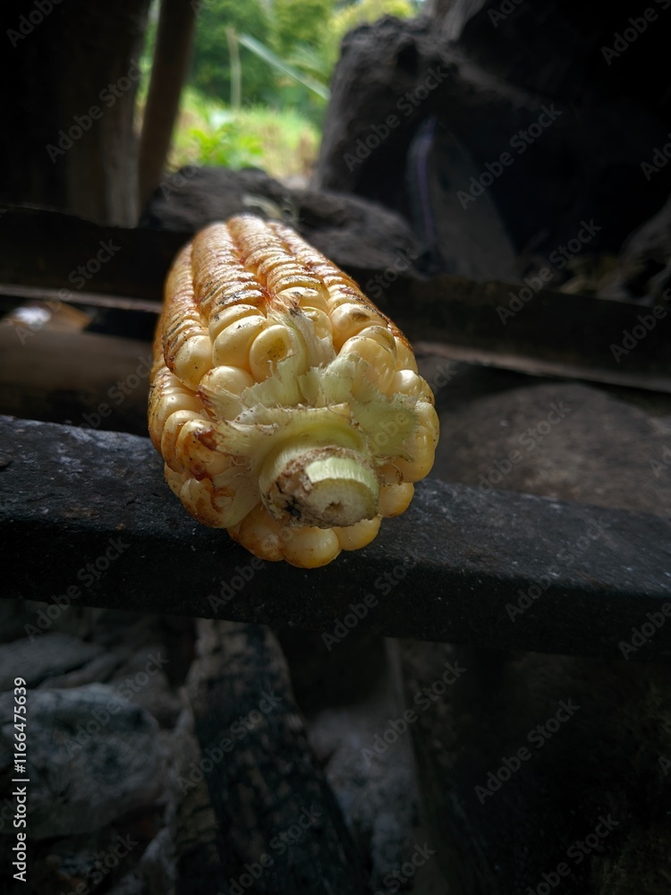 Fototapeta premium Close-up photo of grilled corn in a traditional hut