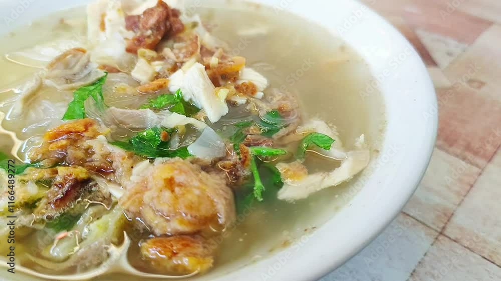 Healthy and delicious traditional Indonesian chicken soup made with chicken, ginger and spices on bokeh background Healthy and delicious traditional Indonesian chicken soup made with chicken, ginger and spices on bokeh background