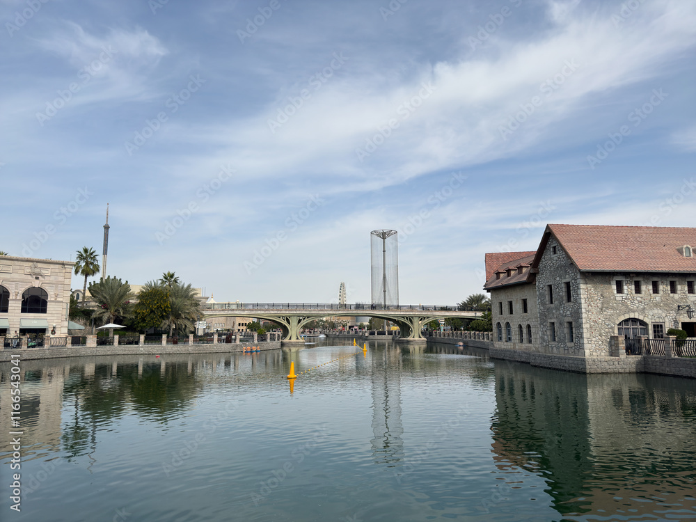 Obraz premium A vibrant snapshot of Riverland Dubai, where charming cobblestone streets, picturesque bridges, and scenic waterways transport you to a world of timeless charm. Lush greenery and European-style.