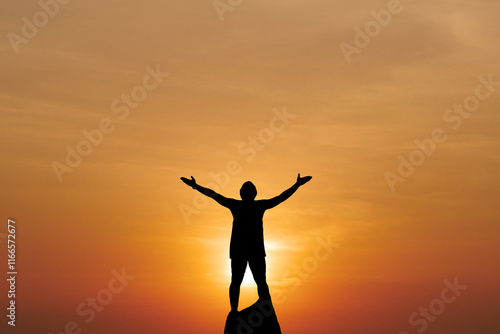 Wallpaper Mural Silhouette of a Person with Outstretched Arms Against a Vibrant Orange Sunset Sky on a Hilltop Torontodigital.ca