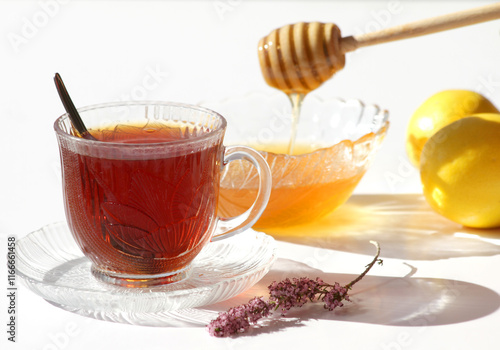 Glass of Turkish Tea and Honey, flower and Lemon isolated on White