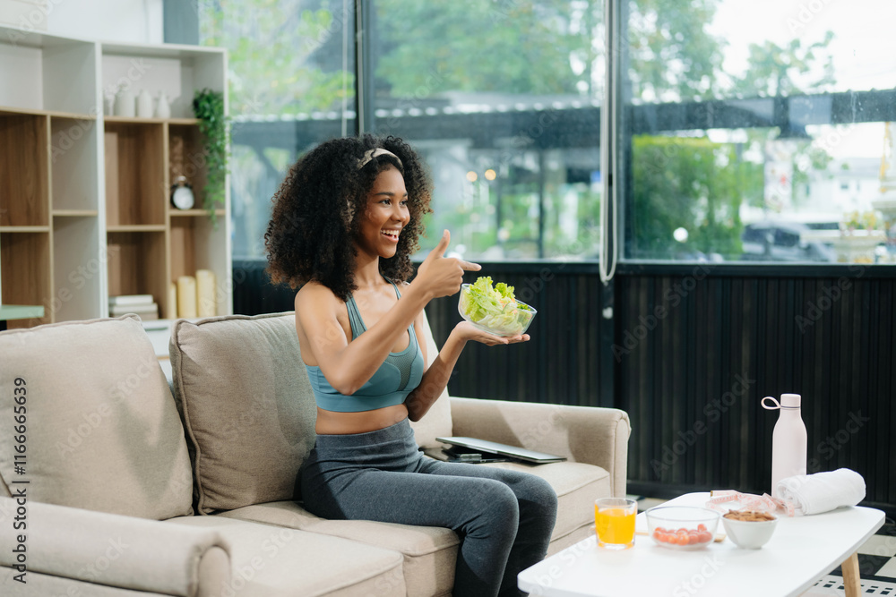 A fit woman enjoys a fresh salad with fruits and juice, embodying wellness, nutrition, and vitality i A fit woman enjoys a fresh salad with fruits and juice, embodying wellness, nutrition, and vitality i