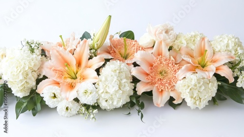 A luxurious floral setup featuring soft peach lilies and ivory carnations, exuding timeless elegance