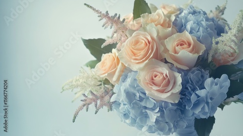 A serene pastel-toned bouquet with peach roses and baby blue hydrangeas, perfect for natural cosmetic design