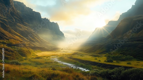 Scenic golden hour glow over lush green valley with misty blue mountains in background and sun rays illuminating tranquil landscape