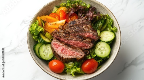 Bowl of vibrant salad with juicy steak cherry tomatoes cucumbers and fresh greens on marble background promoting healthy eating lifestyle