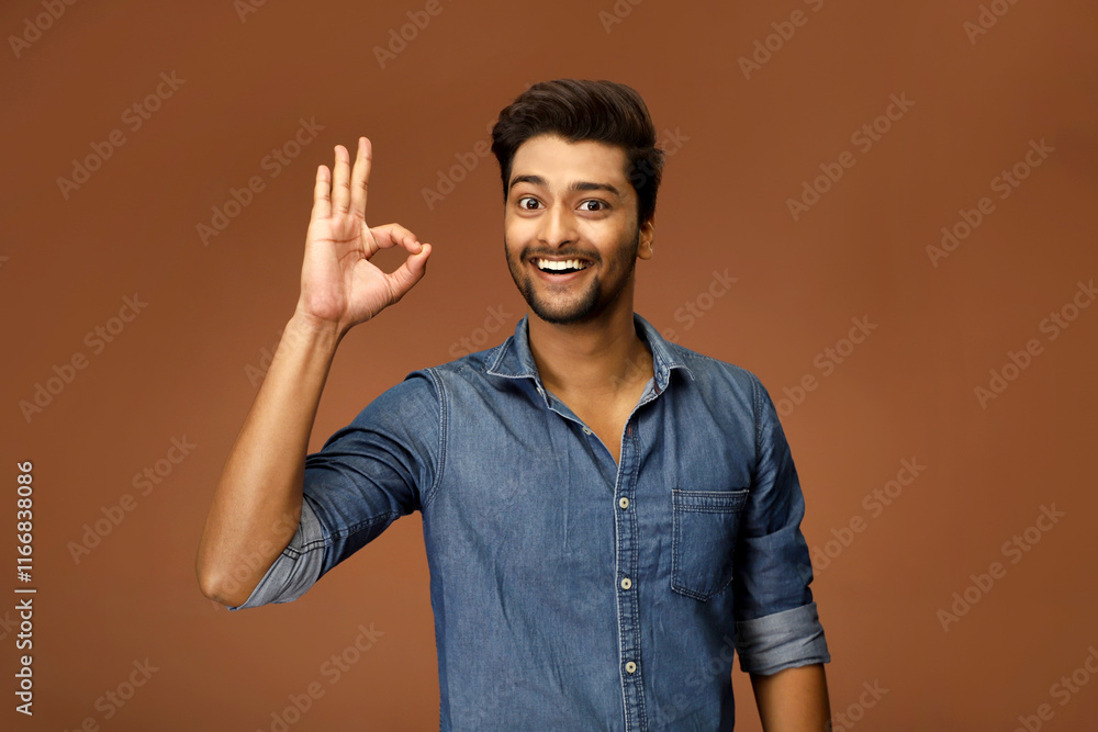 Asian male model with a smile and an OK gesture Asian male model with a smile and an OK gesture