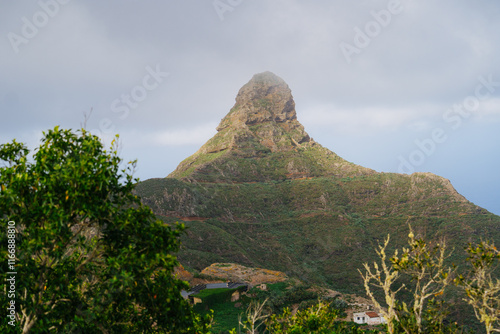 The striking Roque de Taborno rises prominently against a misty sky in Tenerife’s lush Anaga Rural Park. Often referred to as the “Matterhorn of Tenerife,” this volcanic rock formation photo