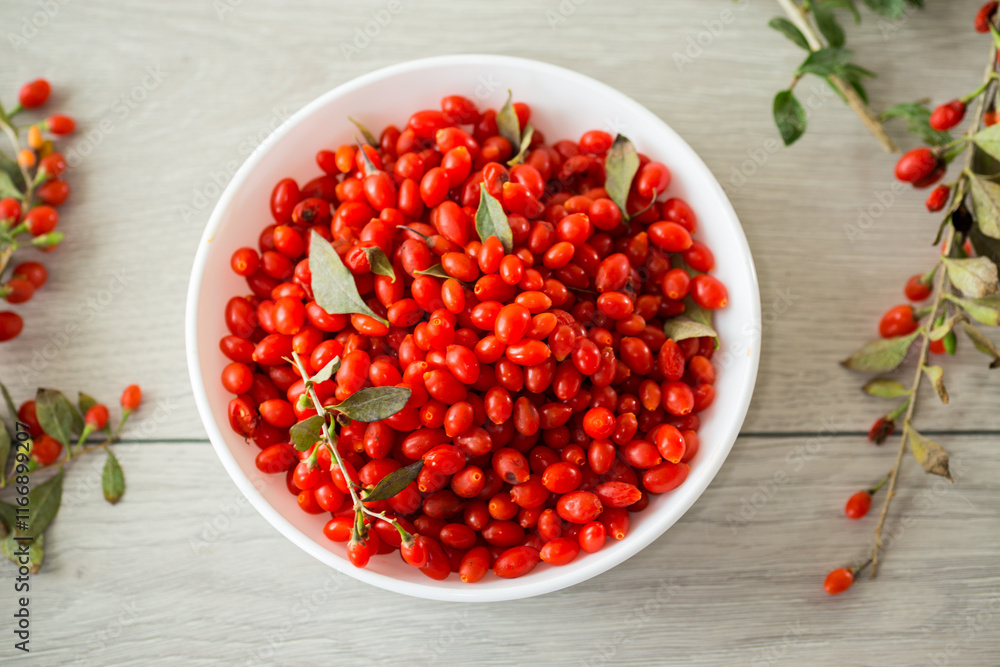 fresh ripe red goji berries in a bowl on a wooden table fresh ripe red goji berries in a bowl on a wooden table