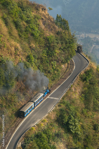 The toy train of Darjeeling heading towards Darjeeling crossing the beautiful landscape view. 