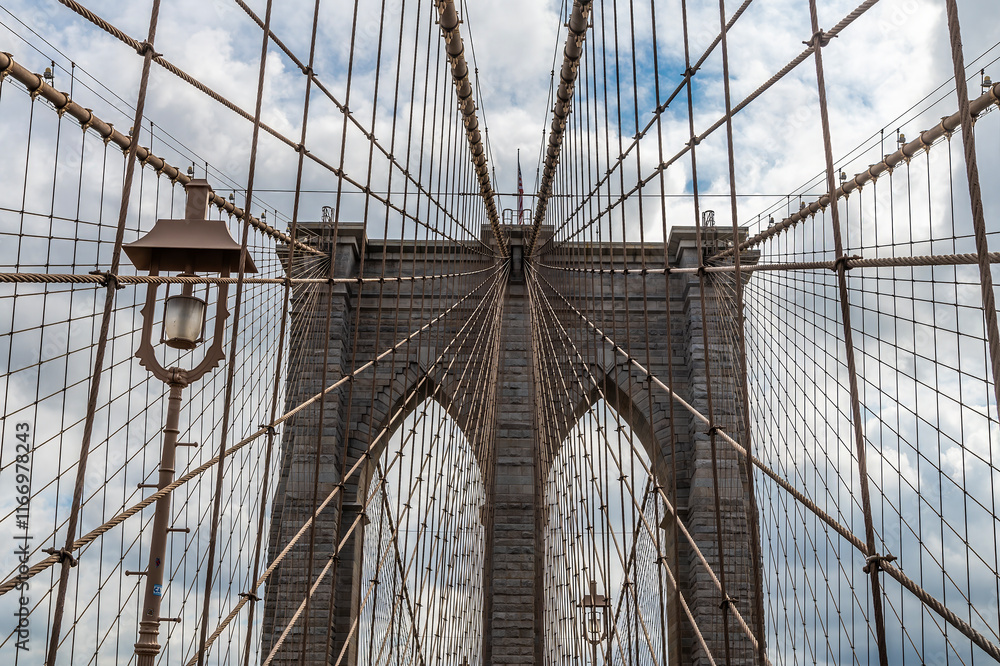 Obraz premium A view looking up at the first support tower on the Brooklyn Bridge leaving Manhattan, New York, in the fall 