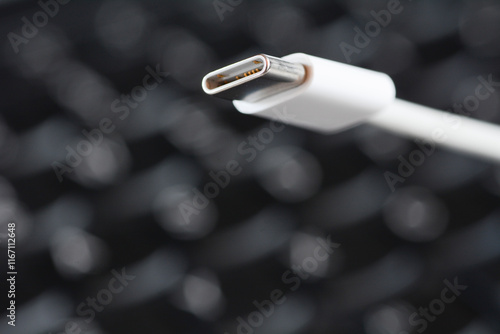 Concept photo of USB-C cable with laptop keyboard