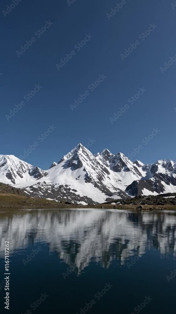 Conveyance pristine wilderness and solitude, wide panoramic shot, snow capped mountain range reflecting in crystal clear alpine lake, cool blue tones with crisp whites.
Conveyance pristine wilderness and solitude, wide panoramic shot, snow capped mountain range reflecting in crystal clear alpine lake, cool blue tones with crisp whites.