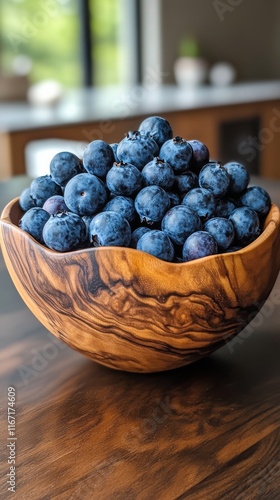 Fresh blueberries in a wooden bowl surrounded by vibrant greenery and colorfu...