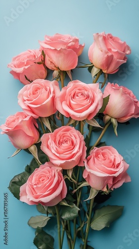 Beautiful bouquet of pink roses arranged against a bright blue background