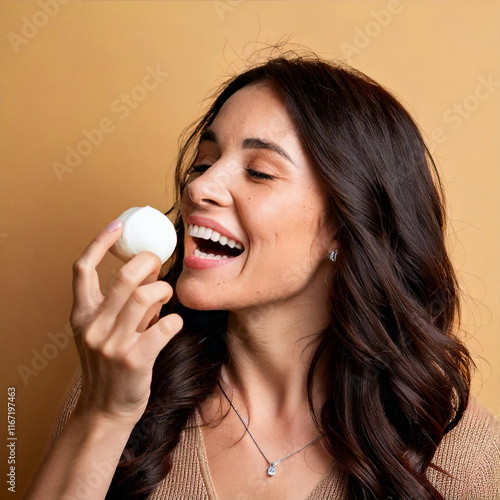 Happy brunette woman eating fresh mozzarella cheese with a smile