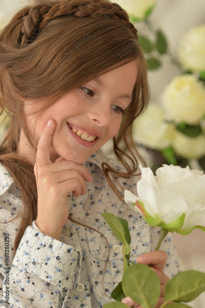 Pretty little girl smiling and posing with flowers Pretty little girl smiling and posing with flowers
