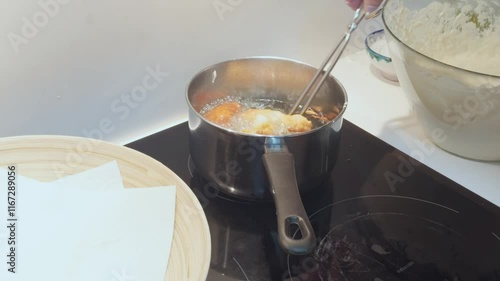 Elderly person making homemade fritters and churros with basic and healthy ingredients such as olive oil and flour.