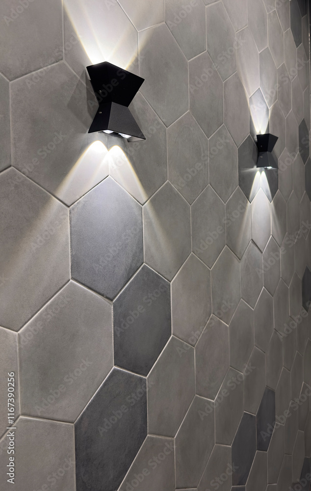 Two lamps on the wall with hexagonal tiles. Two lamps on the wall with hexagonal tiles.