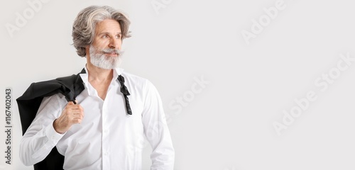 Stylish senior man on light...