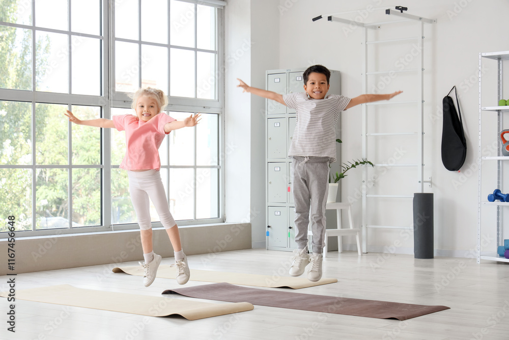 Obraz premium Cute little children jumping in gym