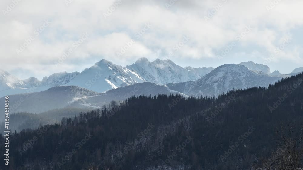 Snow-covered high steep peaks of the Tatra Mountains from the Polish town of Zakopane
