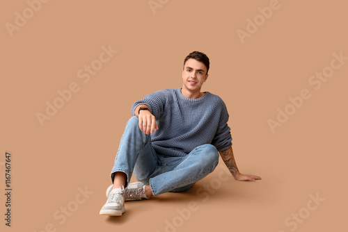 Smiling young man in blue s...