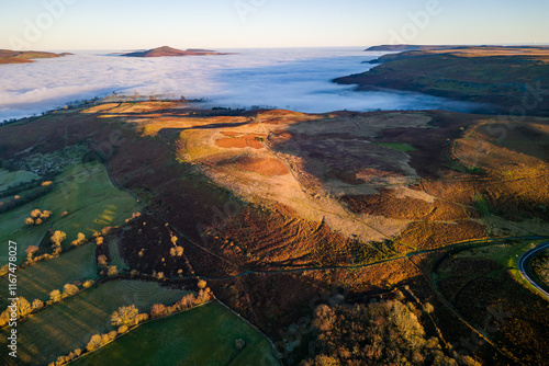 Aerial shot of a fog filled valley and tall hills extending above (Crickhowell, Wales) photo