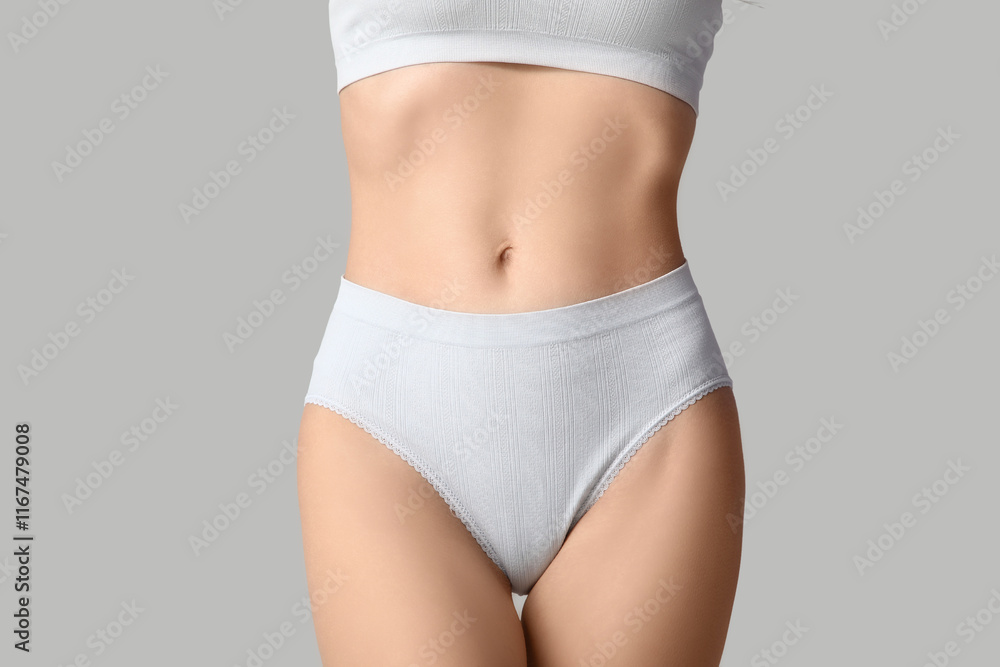 Fototapeta premium Beautiful young woman in white underwear on grey background, closeup