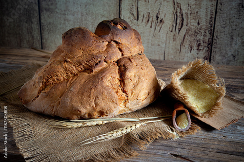 Matera bread, typical bread of basilicata region, italy, resting on rustic wooden table