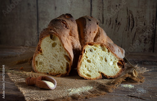 Matera bread, typical bread of basilicata region, italy, resting on rustic wooden table