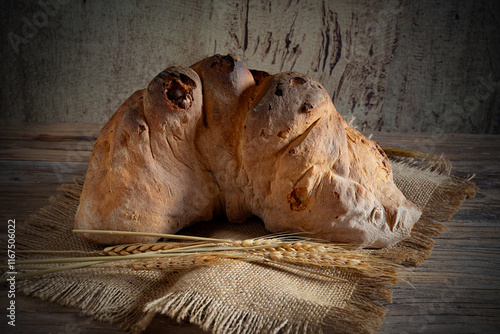Matera bread, typical bread of basilicata region, italy, resting on rustic wooden table