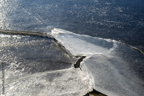 Winter sunny day at a frozen lake with ice floes photo