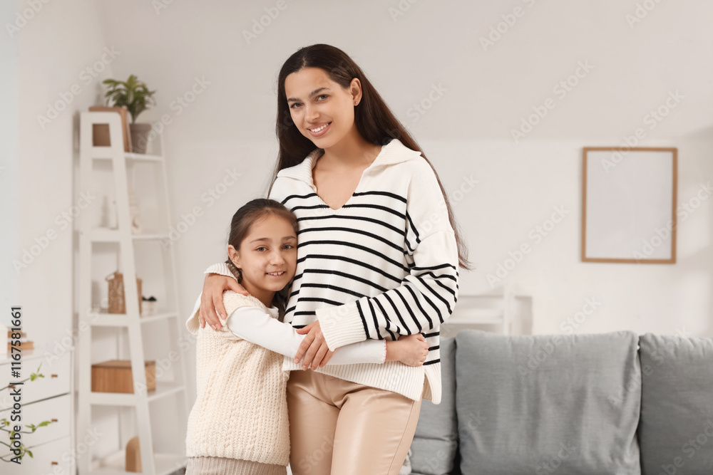 Apologetic mother with her daughter hugging at home Apologetic mother with her daughter hugging at home