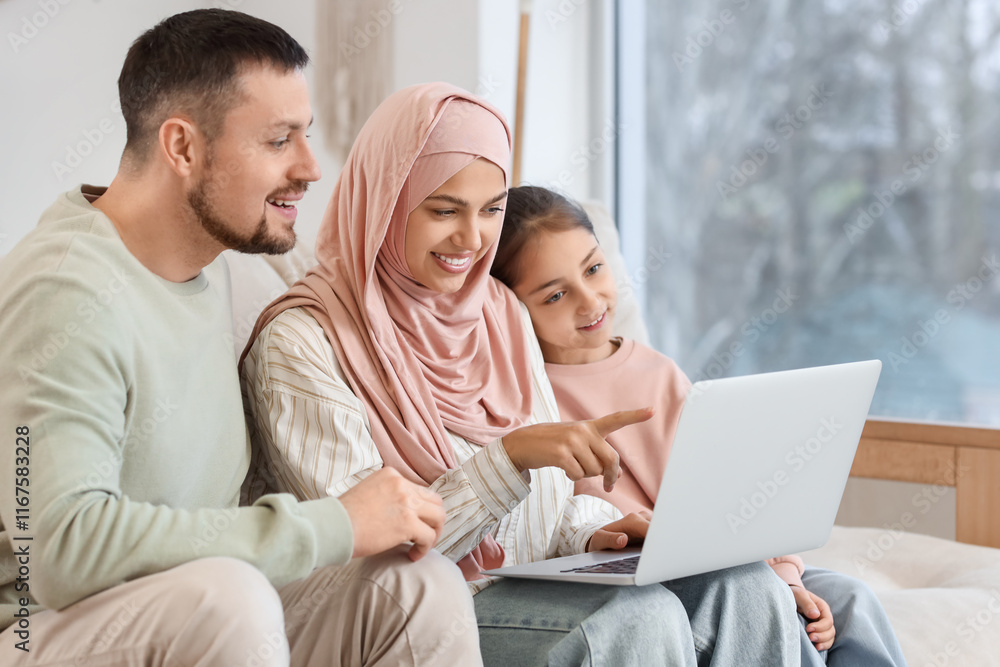 Muslim parents with their daughter using laptop at home Muslim parents with their daughter using laptop at home