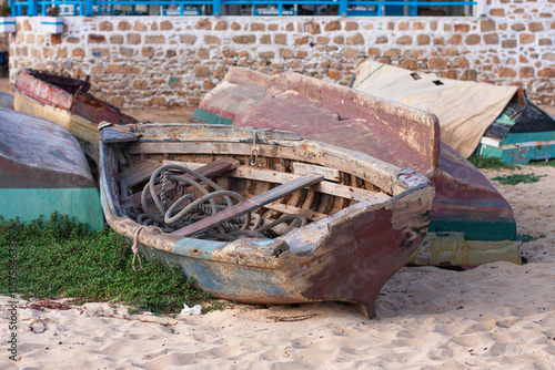 Old fish boat on the sand