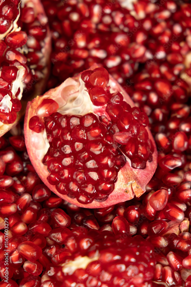 Pomegranate background, lots of peeled pomegranates and seeds Pomegranate background, lots of peeled pomegranates and seeds