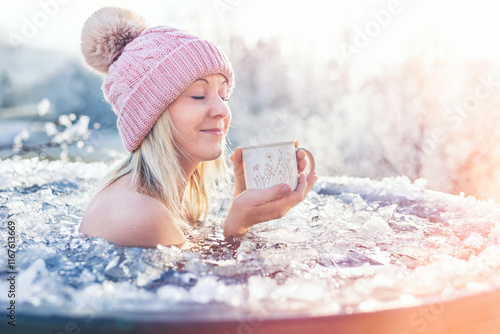 A blonde girl enjoys ice bathing during sunny frozen day, embodying strength, balance, and a healthy lifestyle. This winter challenge showcases her bravery and relaxation amidst the frosty water.