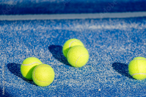 four paddle tennis balls ina padel court, racket sports background concept photo