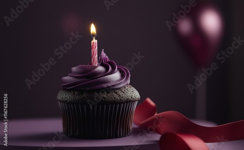 Delicious cupcake with a pink candle and festive ribbons on a purple background