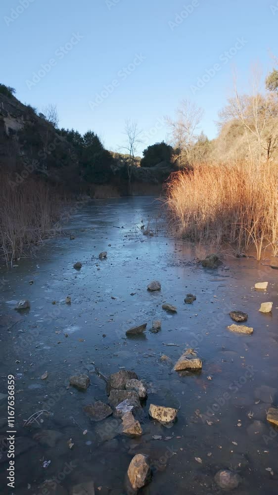 Stone thrown into a river frozen by the intense cold in the mountains of Madrid, Guadarrama. Stone thrown into a river frozen by the intense cold in the mountains of Madrid, Guadarrama.