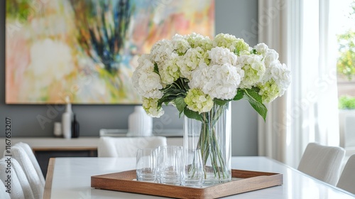 Elegant floral arrangement in modern living space with colorful abstract artwork