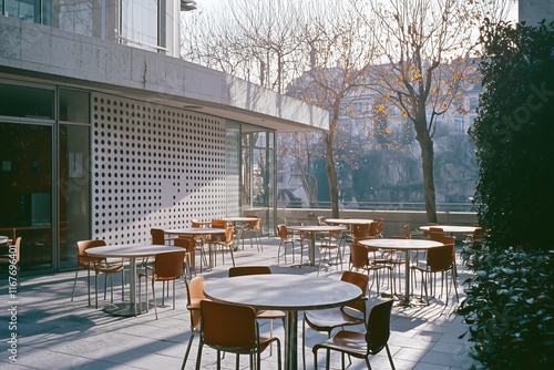 Empty outdoor cafe tables and chairs along the seine river in paris