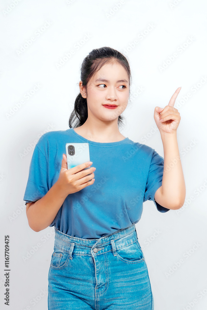 Excited Asian woman pointing at the copy space beside her, isolated on white background Excited Asian woman pointing at the copy space beside her, isolated on white background