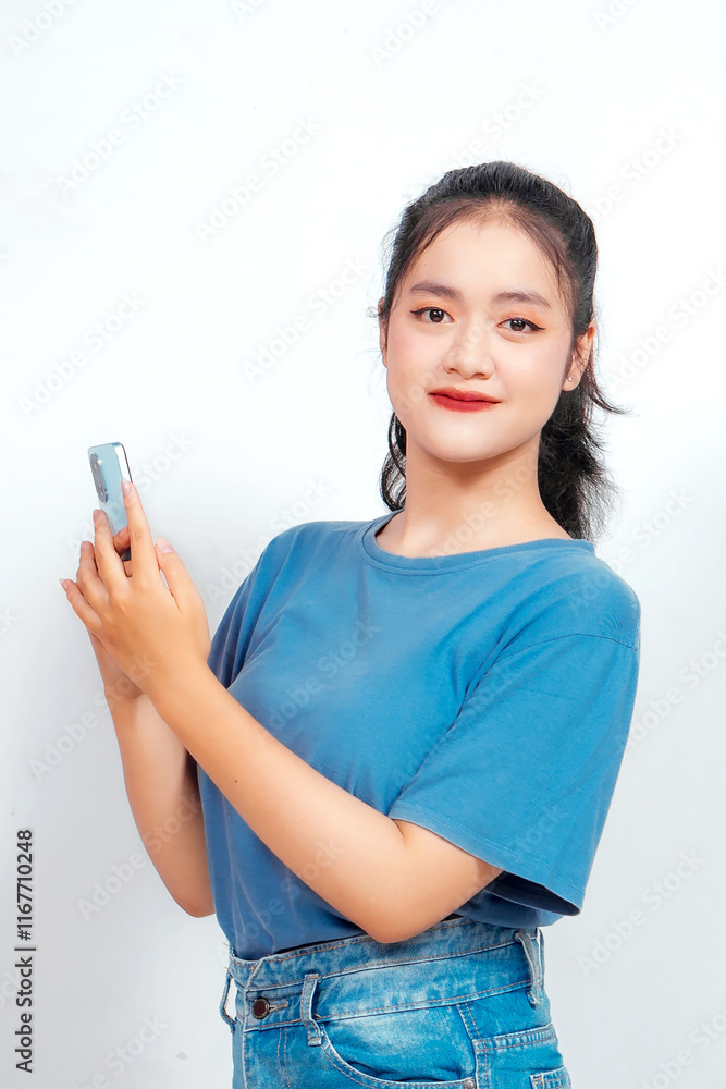 Smiling young Asian woman employee holding her phone, isolated on white background Smiling young Asian woman employee holding her phone, isolated on white background